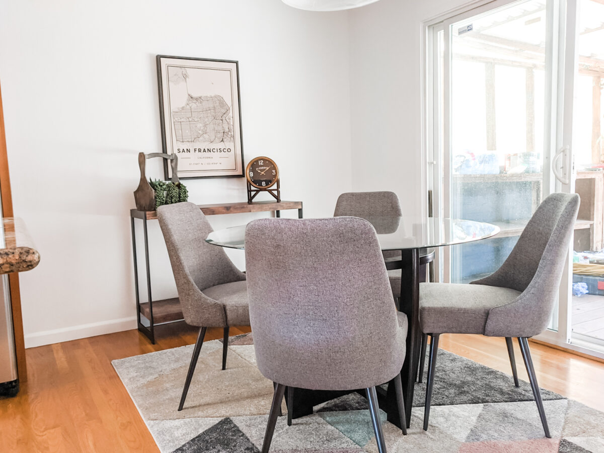 dining room staging with round glass table and luxury chairs