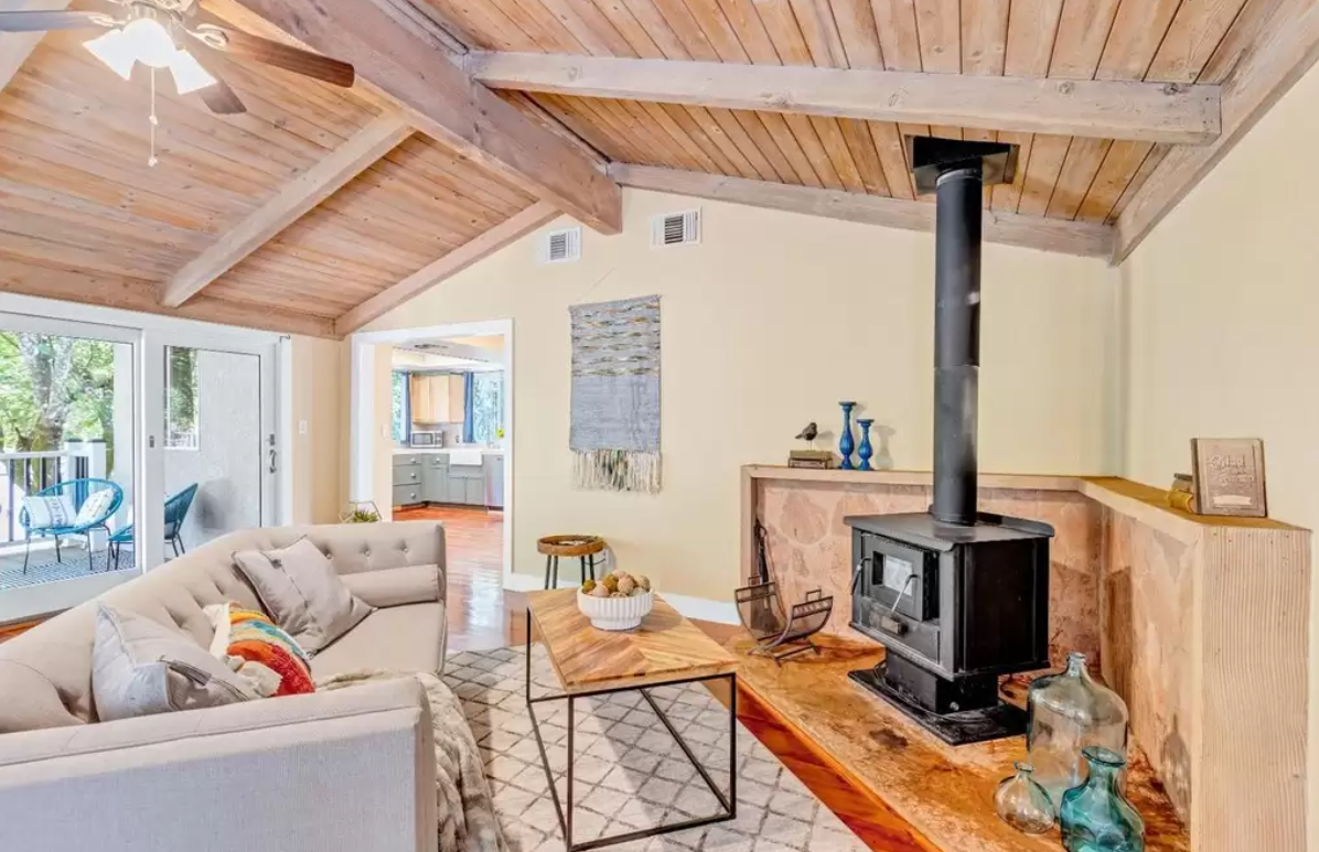staged living room with wood beam ceiling in Northern California cabin