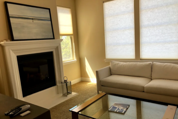 living room with white fireplace and mantel redesigned by Northern California interior designer